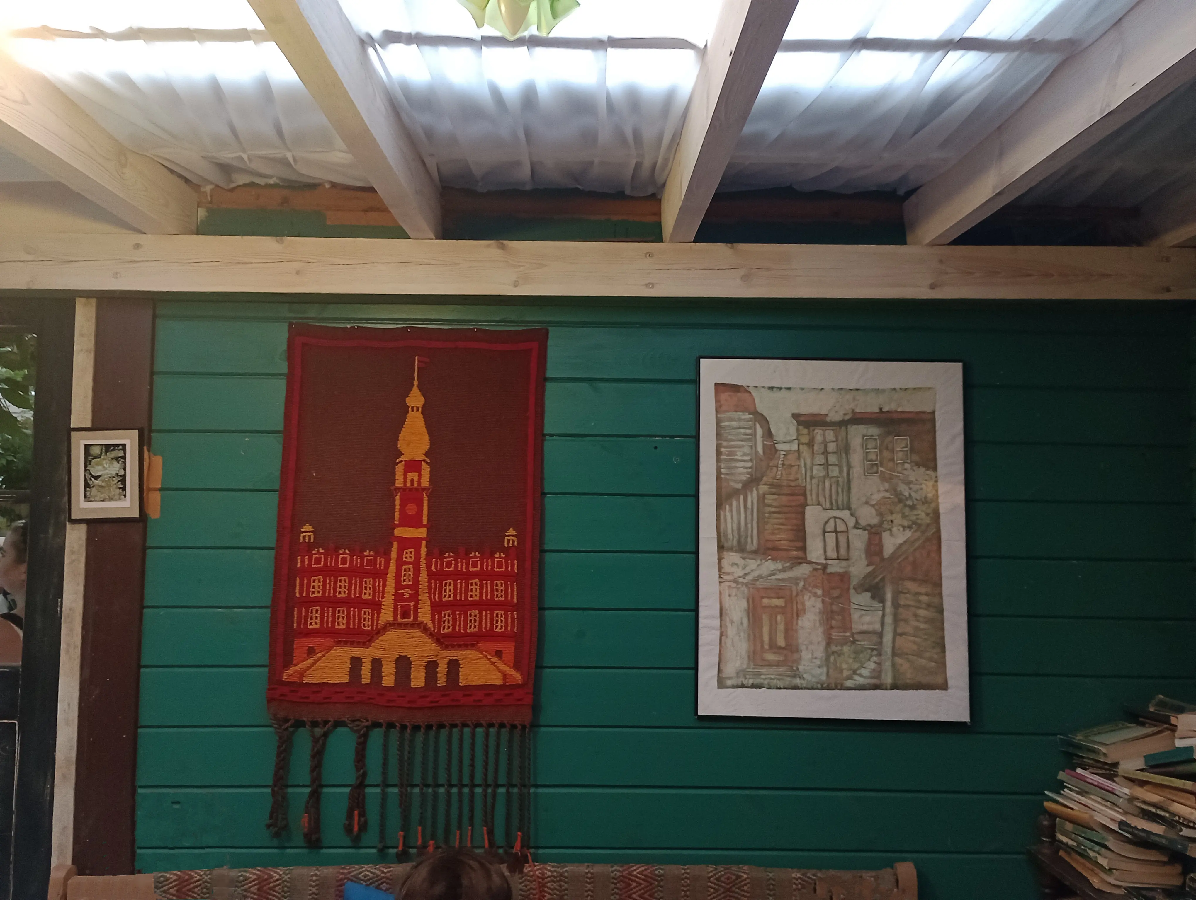 a wall in restaurant with decorative carpets