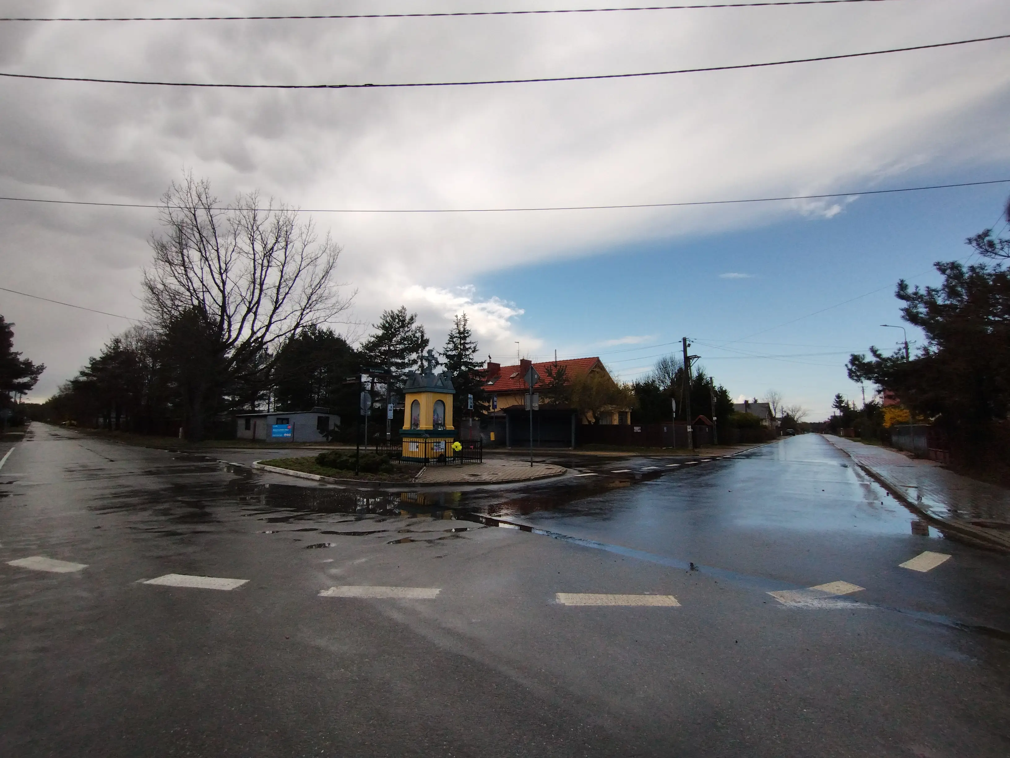 Panoramic photo of the sky that is sharply divided between bright blue and grey sky right after the rain