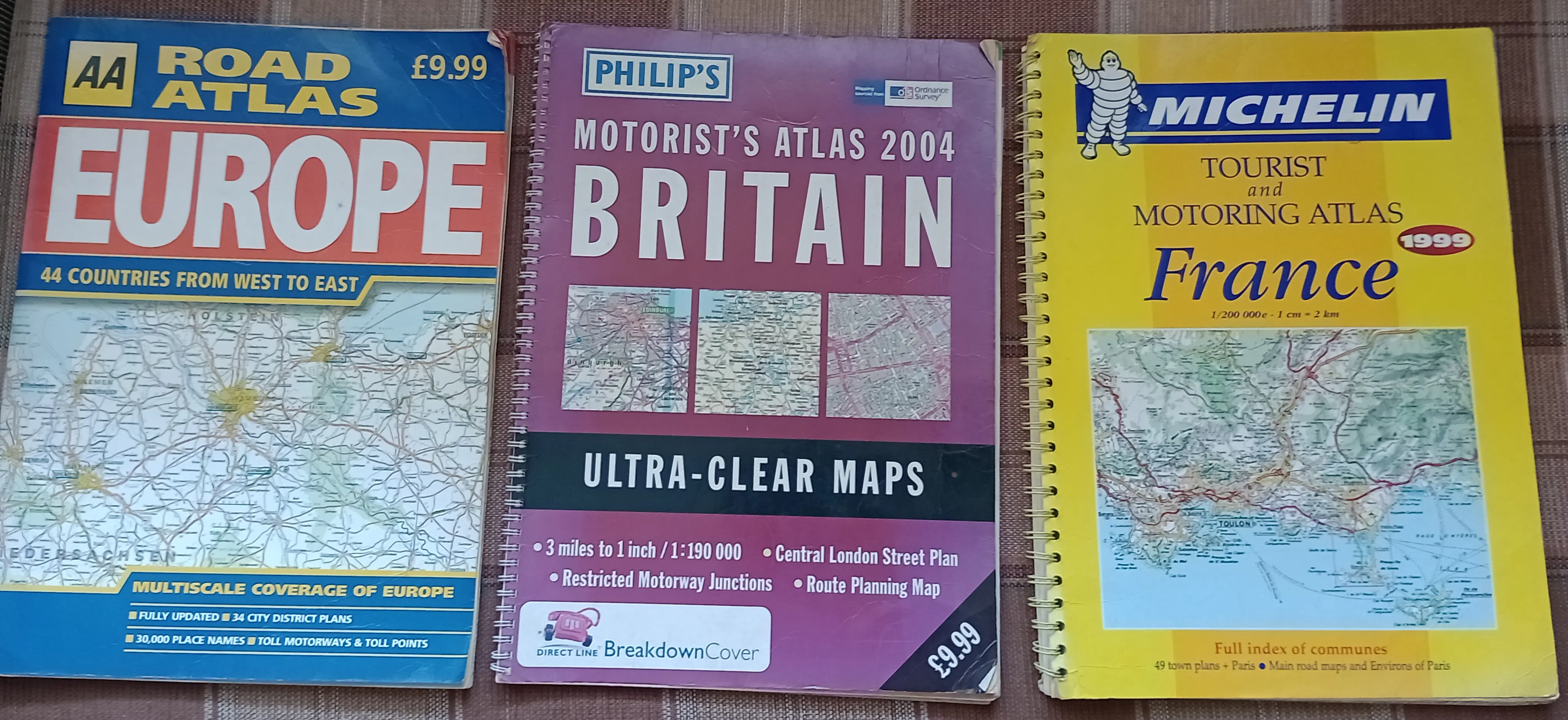 Three paper road atlases of Europe, Great Britain and France